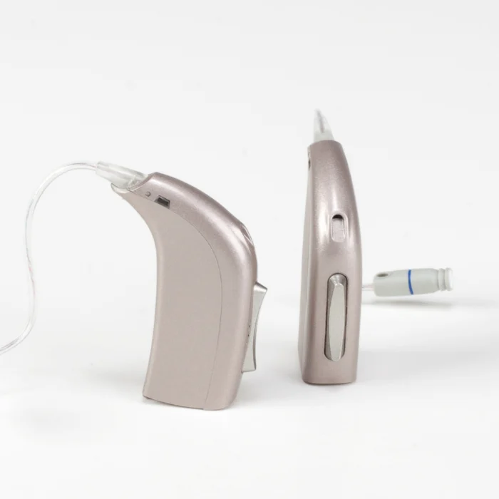 Audiologist carrying out hearing aid fitting during a clinic appointment