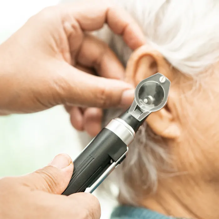 Audiologist carrying out hearing assessment during a clinic appointment