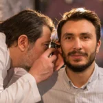 Audiologist carrying out pre-employment hearing test during a clinic appointment